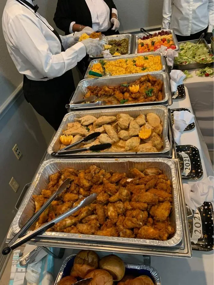 Catering pans of food on a buffet line during service