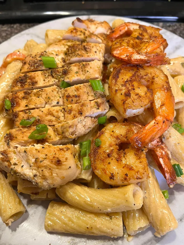 Grilled chicken and shrimp served over rigatoni