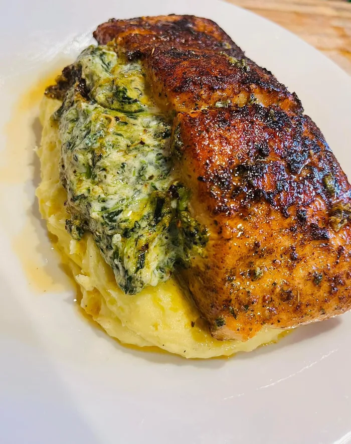 Blackened salmon fillet on creamed spinach and mashed potatoes