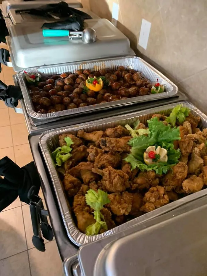 A catering pan of seasoned chicken wings